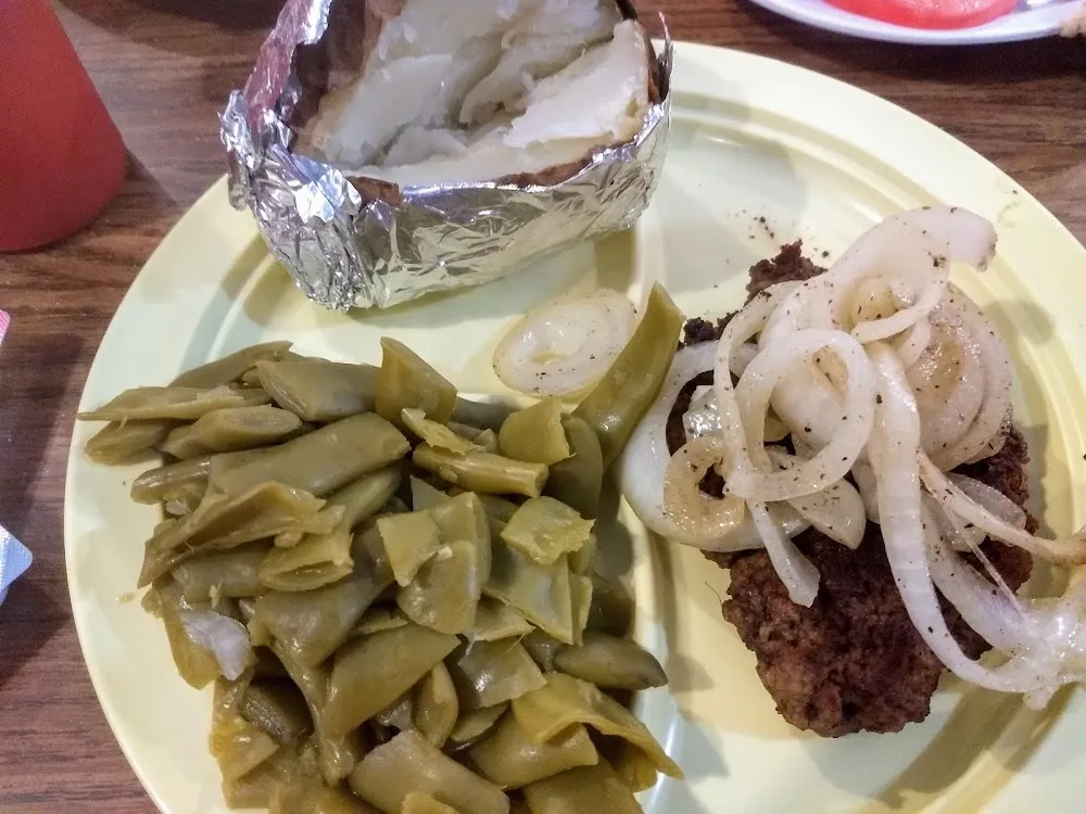 Hamburger Steak with Grilled Onions Green Beans and a Baked Potato